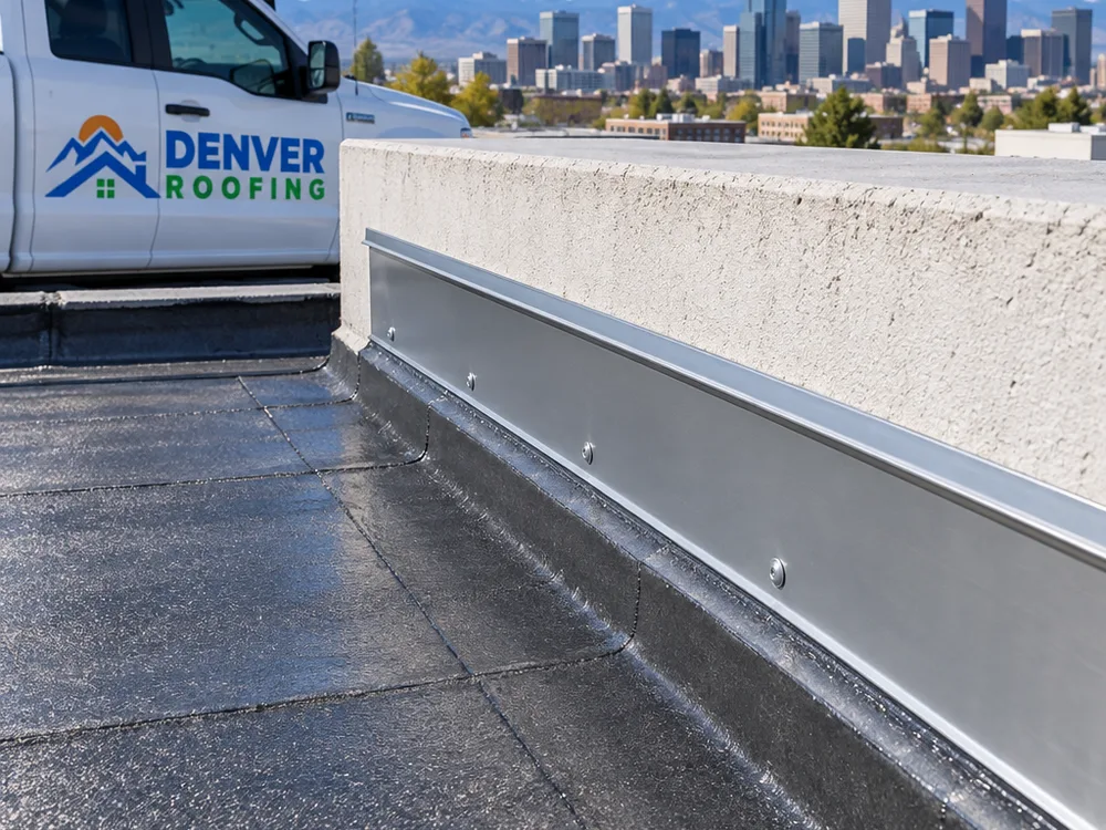 Repaired parapet wall transition with new counterflashing and a sealed termination bar line
